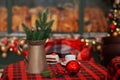 Cup of coffee and christmas toy on wooden table. A copper jug Ã¢â¬â¹Ã¢â¬â¹and fir branches stand on table. Royalty Free Stock Photo
